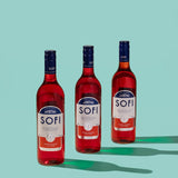 Three bottles of SOFI aperitivo on a teal background