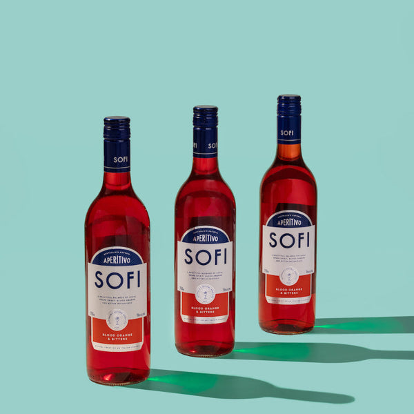 Three bottles of SOFI aperitivo on a teal background