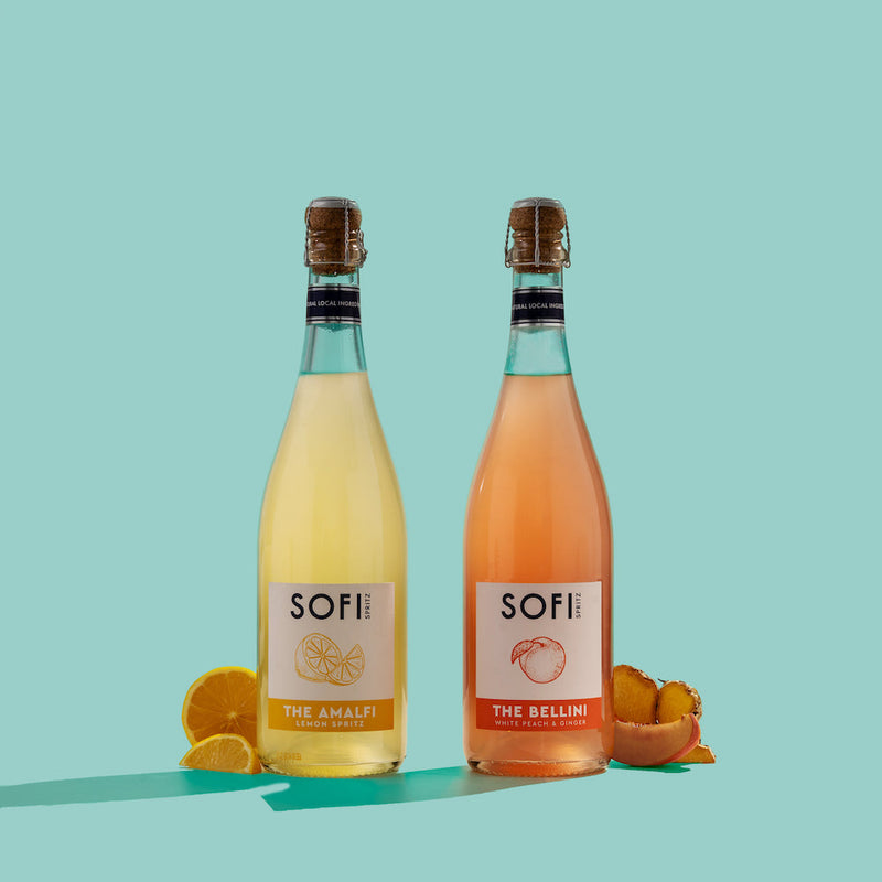Two bottles of SOFI drinks on a light blue background with lemon slices and peach slices.